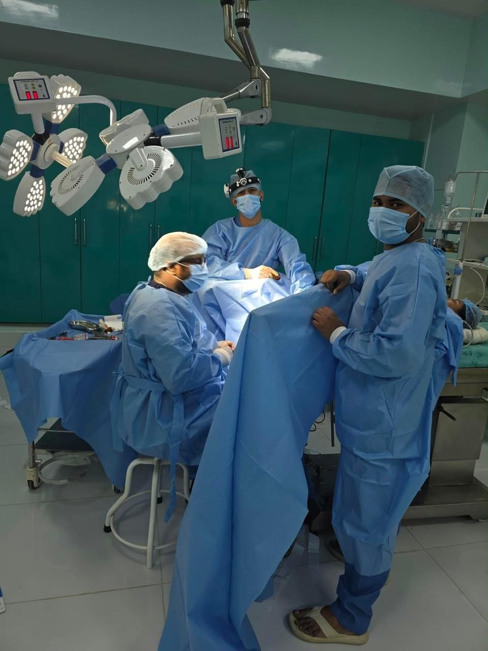 Surgeons operating under theatre lights
